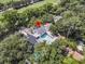 Expansive aerial view of a beautiful home with a backyard pool surrounded by lush greenery and a golf course at 2142 Golfview Dr, Charleston, SC 29412
