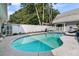 Inviting pool surrounded by a well-kept yard, mature trees and a cozy seating area at 2142 Golfview Dr, Charleston, SC 29412