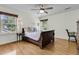 Comfortable bedroom with a wooden sleigh bed, side tables with lamps, and windows with tree views at 2142 Golfview Dr, Charleston, SC 29412
