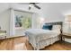 Bright bedroom with large windows, hardwood floors, and a cozy bed at 2142 Golfview Dr, Charleston, SC 29412
