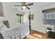 Bright bedroom featuring a four poster bed, wood floors, a ceiling fan, and light paint at 2142 Golfview Dr, Charleston, SC 29412