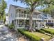 Charming two-story home with dual balconies, manicured landscaping, and side driveway at 2142 Golfview Dr, Charleston, SC 29412