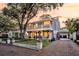 Charming two-story home with dual balconies, brick driveway, mature landscaping, and a convenient carport at 2142 Golfview Dr, Charleston, SC 29412