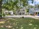 Charming two-story home featuring dual balconies, mature trees, and a long driveway at 2142 Golfview Dr, Charleston, SC 29412