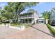 Charming home with brick driveway, covered porch, and mature landscaping at 2142 Golfview Dr, Charleston, SC 29412