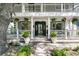 Inviting front porch with potted plants and hanging flowers at 2142 Golfview Dr, Charleston, SC 29412