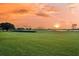 Scenic golf course view with lush green grass and a tranquil pond at sunset at 2142 Golfview Dr, Charleston, SC 29412