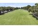 Expansive golf course with lush green grass, sand traps, and tree lined fairways under a sunny sky at 2142 Golfview Dr, Charleston, SC 29412