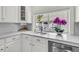 Charming kitchen featuring white marble countertops and a window with a view of the pool at 2142 Golfview Dr, Charleston, SC 29412
