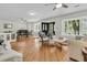 Open-concept living space featuring elegant furnishings, hardwood floors, and a seamless flow between living and dining areas at 2142 Golfview Dr, Charleston, SC 29412