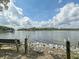 Scenic waterfront view with bench seating, lush greenery, and the tranquil river under a partly cloudy blue sky at 2142 Golfview Dr, Charleston, SC 29412