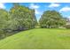 Beautiful backyard featuring mature trees, lush grass, and a small stream for a serene outdoor setting at 2174 Bees Ferry Rd # G, Charleston, SC 29414