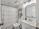 Clean bathroom with a patterned shower curtain, open shelves, and a sleek vanity sink at 2174 Bees Ferry Rd # G, Charleston, SC 29414