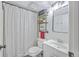 Well-lit bathroom featuring a shower with patterned curtains, storage shelves, and a vanity sink at 2174 Bees Ferry Rd # G, Charleston, SC 29414