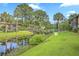 Scenic view of the community featuring a waterway, bridge, lush landscaping, and neighboring condo buildings at 2174 Bees Ferry Rd # G, Charleston, SC 29414