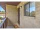 Condo exterior featuring tan stucco, a unit entrance door, and a window with a view of palm trees at 2174 Bees Ferry Rd # G, Charleston, SC 29414