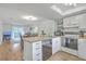 Open kitchen with white cabinets, wooden countertop, stainless steel dishwasher, and a view into the dining area at 2174 Bees Ferry Rd # G, Charleston, SC 29414