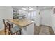 Bright kitchen featuring white cabinets, a butcher block countertop island with bar stool seating at 2174 Bees Ferry Rd # G, Charleston, SC 29414