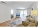 Bright living room features a neutral sofa, area rug, television, and sliding glass doors to an outdoor space at 2174 Bees Ferry Rd # G, Charleston, SC 29414