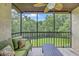 Cozy screened patio with comfortable seating, table, and serene views of lush green trees at 2174 Bees Ferry Rd # G, Charleston, SC 29414