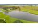 Scenic aerial view of a lush golf course with a tranquil lake and a bridge in the background at 2217 Ramsay St, Charleston, SC 29412