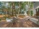 Backyard deck has a charming patio with outdoor chairs and firepit perfect for entertaining at 2217 Ramsay St, Charleston, SC 29412