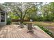 Charming backyard deck and seating area with a view of lush landscaping and mature trees at 2217 Ramsay St, Charleston, SC 29412
