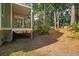 View of shady backyard with the house on stilts and a peek at the marsh at 2217 Ramsay St, Charleston, SC 29412