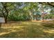 Expansive backyard with mature trees, providing ample shade and privacy at 2217 Ramsay St, Charleston, SC 29412