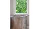 Close up of sleek soaking tub by a window with greenery at 2217 Ramsay St, Charleston, SC 29412
