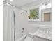 Bathroom with a shower and tub combination plus white tile and a marble sink at 2217 Ramsay St, Charleston, SC 29412