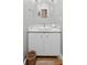 Charming bathroom features a marble countertop, white cabinets, and a round mirror at 2217 Ramsay St, Charleston, SC 29412