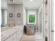 Modern bathroom with unique soaking tub, double vanity, and glass-enclosed shower at 2217 Ramsay St, Charleston, SC 29412