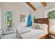 Bedroom featuring a bed, exposed beams, and a door to the outside back porch at 2217 Ramsay St, Charleston, SC 29412