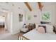 Bright bedroom with vaulted ceilings, exposed beams, and ample natural light from two windows at 2217 Ramsay St, Charleston, SC 29412