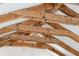 Close up of a ceiling with exposed beams and white panels, showing the roof trusses at 2217 Ramsay St, Charleston, SC 29412