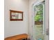 Charming entryway with a rustic mirror, bench, and an open door offering views of the backyard and basketball court at 2217 Ramsay St, Charleston, SC 29412