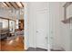 Entryway with wooden floors, white door, and an open view to the spacious living area beyond at 2217 Ramsay St, Charleston, SC 29412