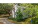 Charming home featuring gray siding, complemented by lush landscaping and a welcoming driveway at 2217 Ramsay St, Charleston, SC 29412