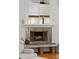 Close up of the modern looking fireplace with white mantle and accent brick-like material at 2217 Ramsay St, Charleston, SC 29412