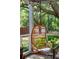 Close up of hanging rattan chair on the porch with outdoor summer scenery at 2217 Ramsay St, Charleston, SC 29412