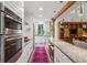 Spacious kitchen with granite counters, stainless appliances, exposed beams, and island seating at 2217 Ramsay St, Charleston, SC 29412