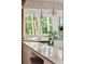 Bright kitchen island with granite countertops and pendant lighting with large windows at 2217 Ramsay St, Charleston, SC 29412