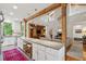 Bright open kitchen and living space with granite island and exposed beams at 2217 Ramsay St, Charleston, SC 29412