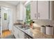 Bright kitchen with granite countertops, stainless sink, and a view of the backyard at 2217 Ramsay St, Charleston, SC 29412
