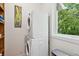 Modern laundry room features a stacked washer and dryer with window and natural light at 2217 Ramsay St, Charleston, SC 29412