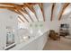 Upstairs living area featuring exposed wood beams, white walls, and lots of natural light at 2217 Ramsay St, Charleston, SC 29412