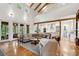 Sun-filled open living space featuring hardwood floors, exposed beams, and seamless flow at 2217 Ramsay St, Charleston, SC 29412