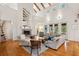 Bright living room with hardwood floors, a fireplace, and lots of natural light from the tall windows at 2217 Ramsay St, Charleston, SC 29412