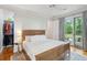 Cozy main bedroom with hardwood floors, ceiling fan, and sliding doors to a private deck at 2217 Ramsay St, Charleston, SC 29412